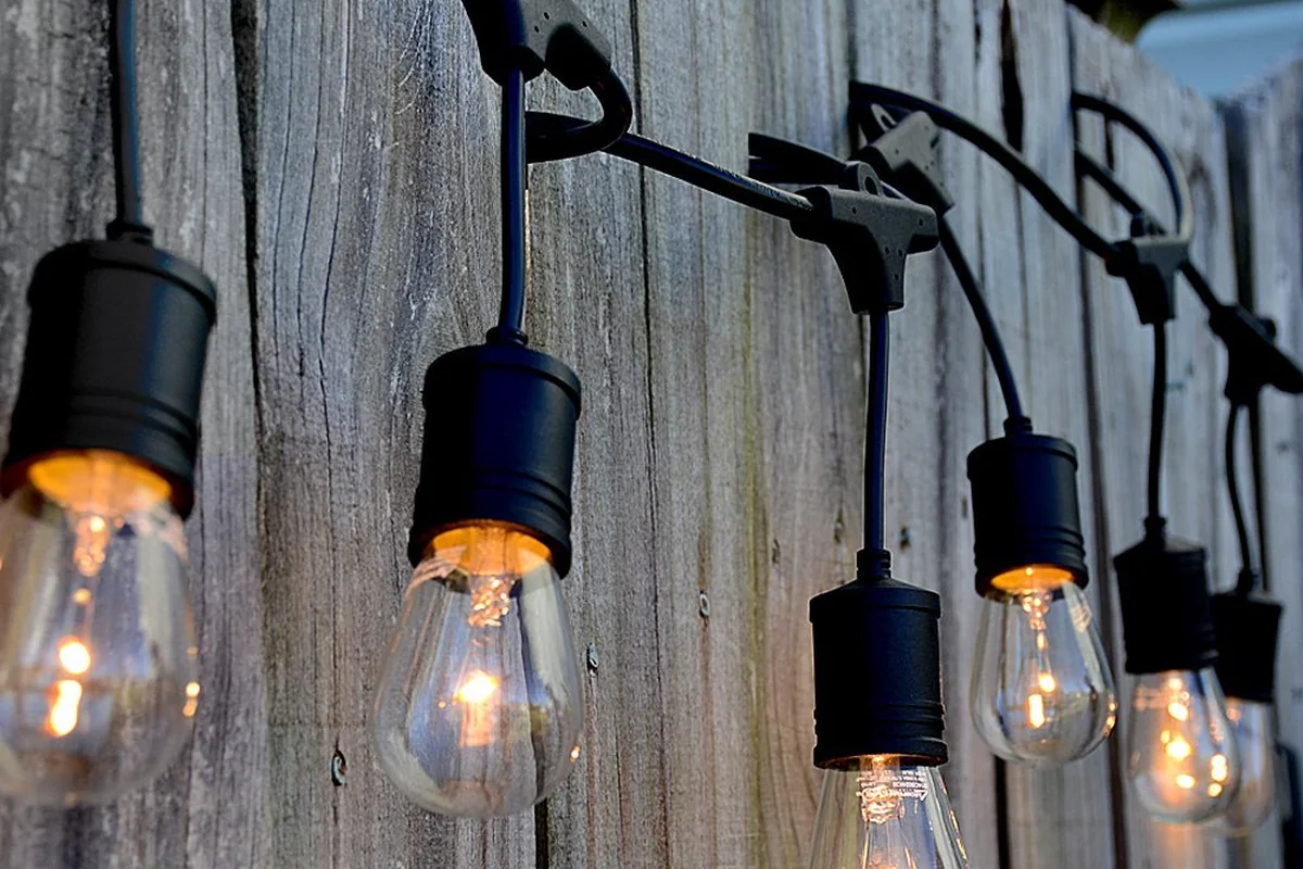 LSL string light fixed along a wooden fence